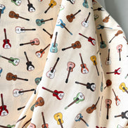 Tossed Guitars- 100% Cotton Fabric- On Cream- 44” Wide