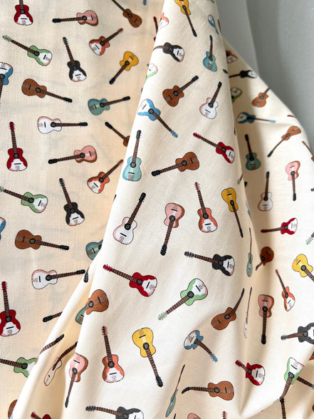 Tossed Guitars- 100% Cotton Fabric- On Cream- 44” Wide
