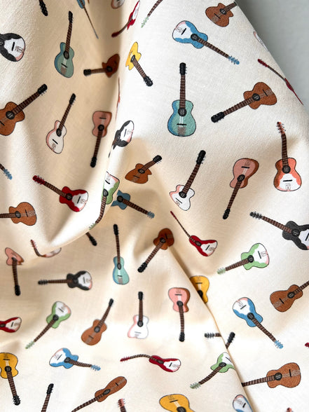 Tossed Guitars- 100% Cotton Fabric- On Cream- 44” Wide