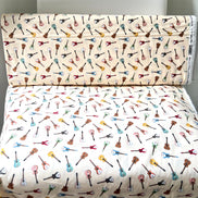 Tossed Guitars- 100% Cotton Fabric- On Cream- 44” Wide
