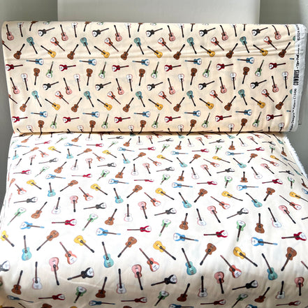 Tossed Guitars- 100% Cotton Fabric- On Cream- 44” Wide