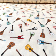 Tossed Guitars- 100% Cotton Fabric- On Cream- 44” Wide