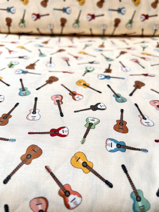 Tossed Guitars- 100% Cotton Fabric- On Cream- 44” Wide