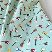 Tossed Guitars- 100% Cotton Fabric- On Light Teal/ Aqua- 44” Wide