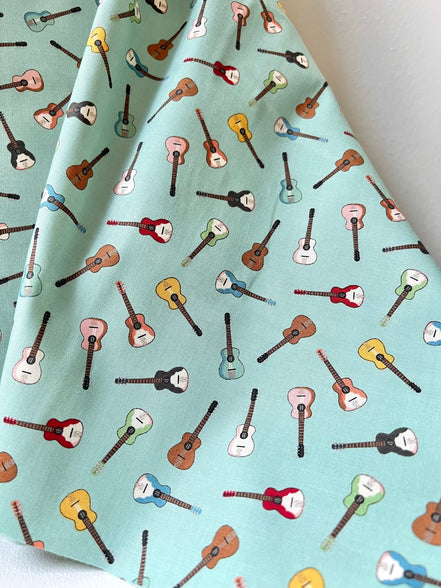 Tossed Guitars- 100% Cotton Fabric- On Light Teal/ Aqua- 44” Wide