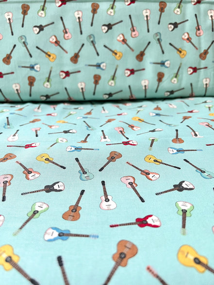 Tossed Guitars- 100% Cotton Fabric- On Light Teal/ Aqua- 44” Wide