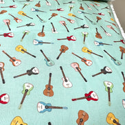 Tossed Guitars- 100% Cotton Fabric- On Light Teal/ Aqua- 44” Wide