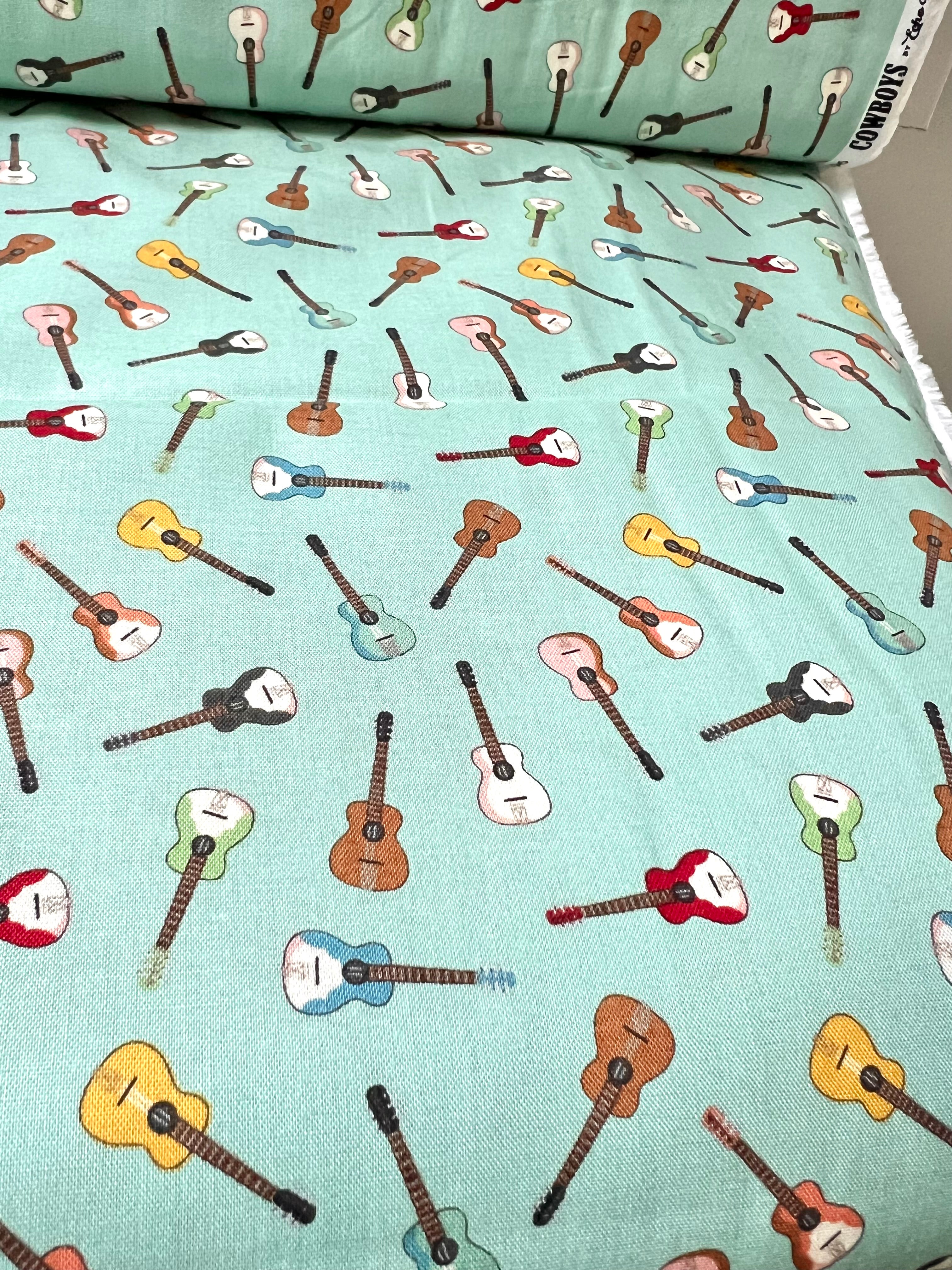 Tossed Guitars- 100% Cotton Fabric- On Light Teal/ Aqua- 44” Wide