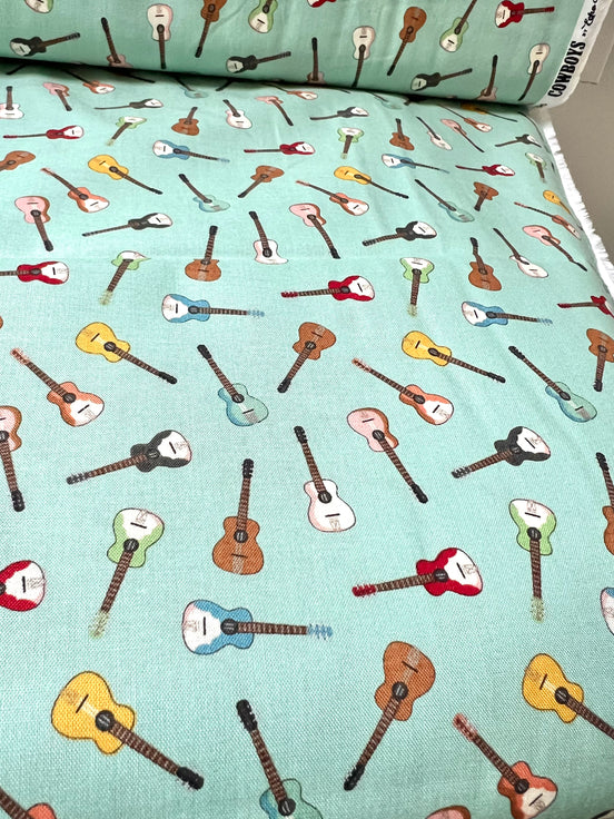 Tossed Guitars- 100% Cotton Fabric- On Light Teal/ Aqua- 44” Wide