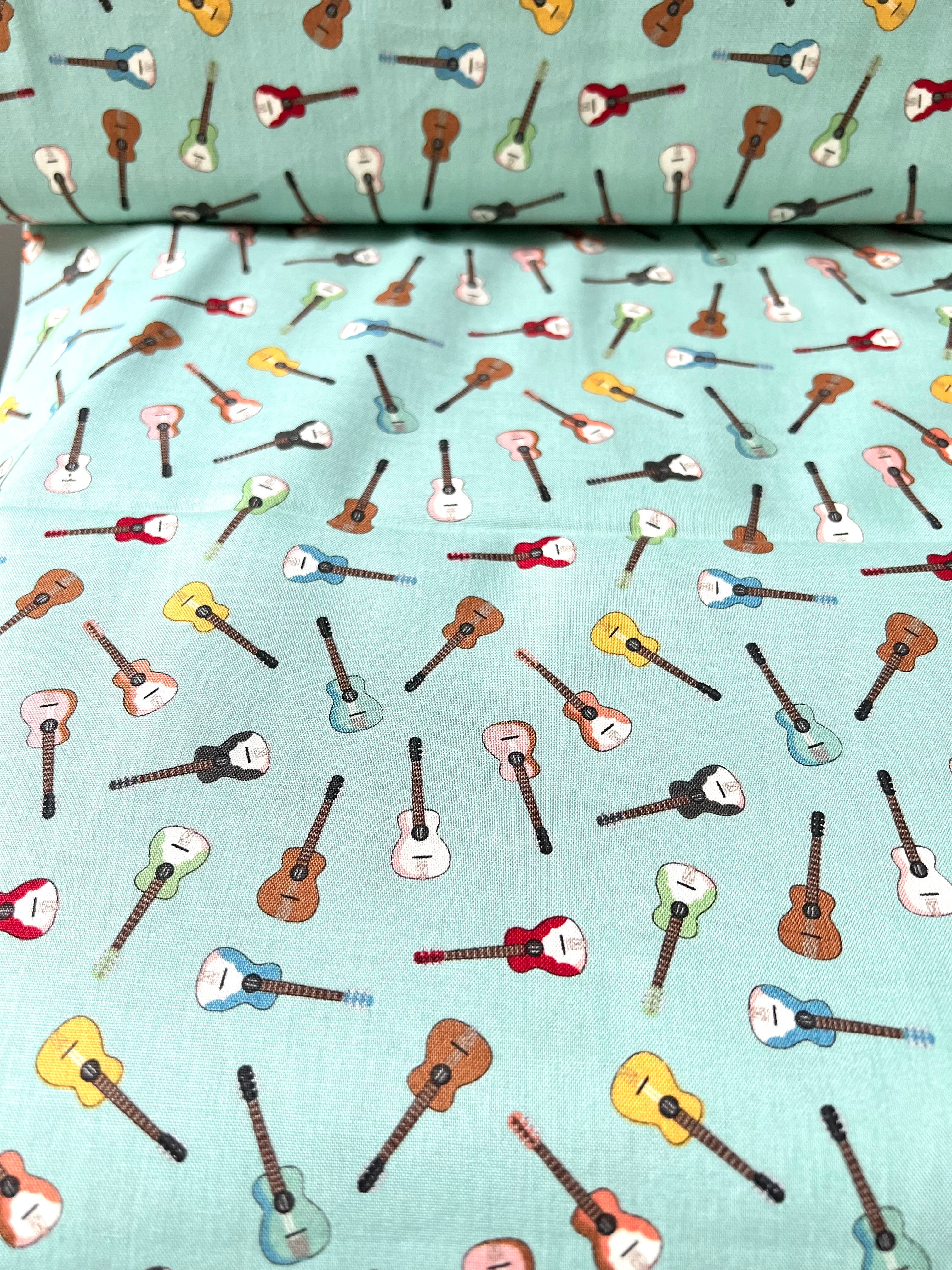 Tossed Guitars- 100% Cotton Fabric- On Light Teal/ Aqua- 44” Wide