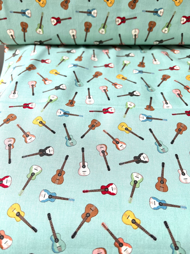 Tossed Guitars- 100% Cotton Fabric- On Light Teal/ Aqua- 44” Wide