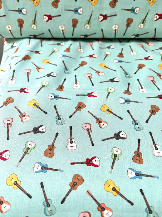 Tossed Guitars- 100% Cotton Fabric- On Light Teal/ Aqua- 44” Wide