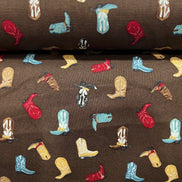 Tossed Cowboy Boots- 100% Cotton Fabric- On Brown- 44” Wide