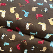 Tossed Cowboy Boots- 100% Cotton Fabric- On Brown- 44” Wide