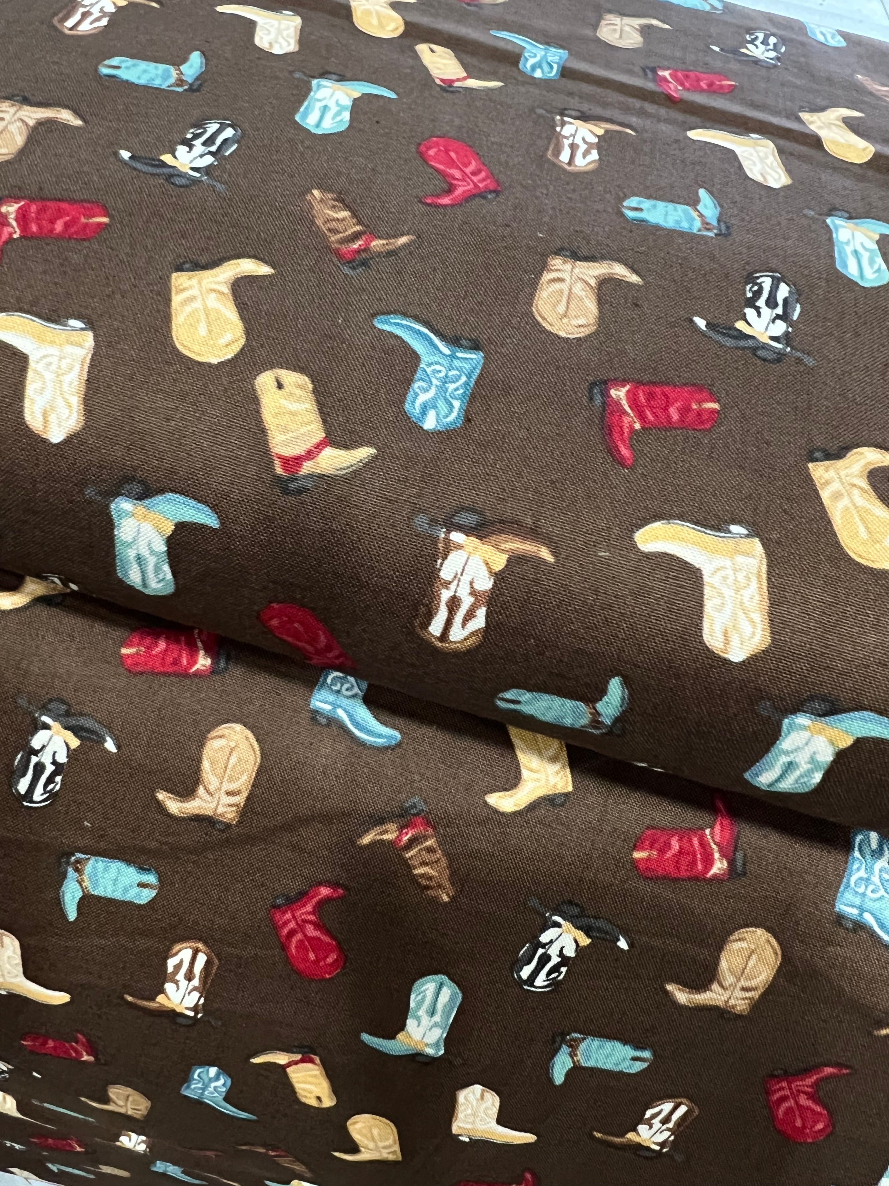 Tossed Cowboy Boots- 100% Cotton Fabric- On Brown- 44” Wide